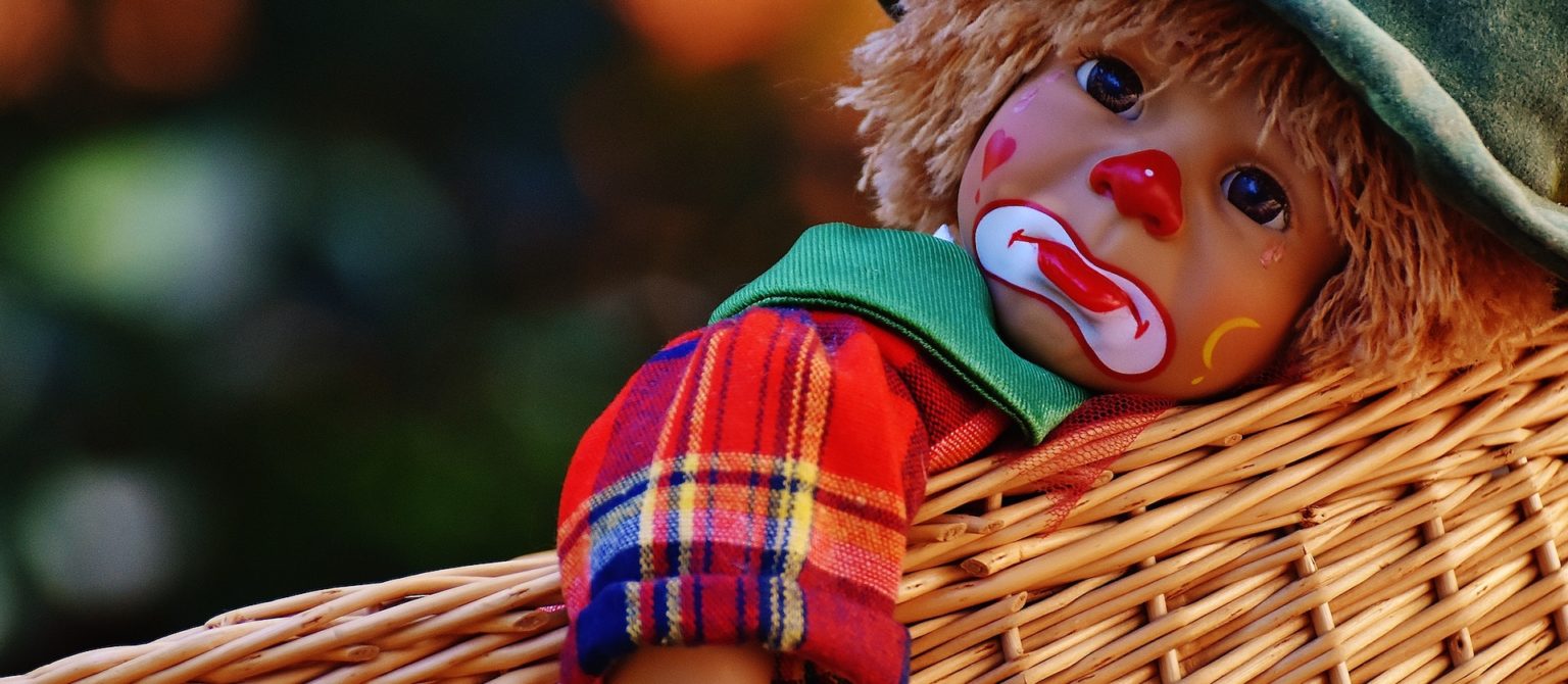 Symbol for Unfunny Like a Clown: The Power and Pitfalls of Humorous Marketing Content: Image of young sad clown doll.