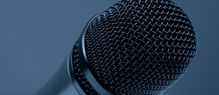 A microphone represents amplifying your brand with customer testimonials in B2B marketing.