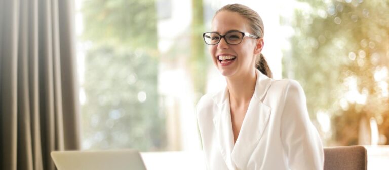 An image of a smiling woman represents the good impression that B2B case studies can make on buyers.