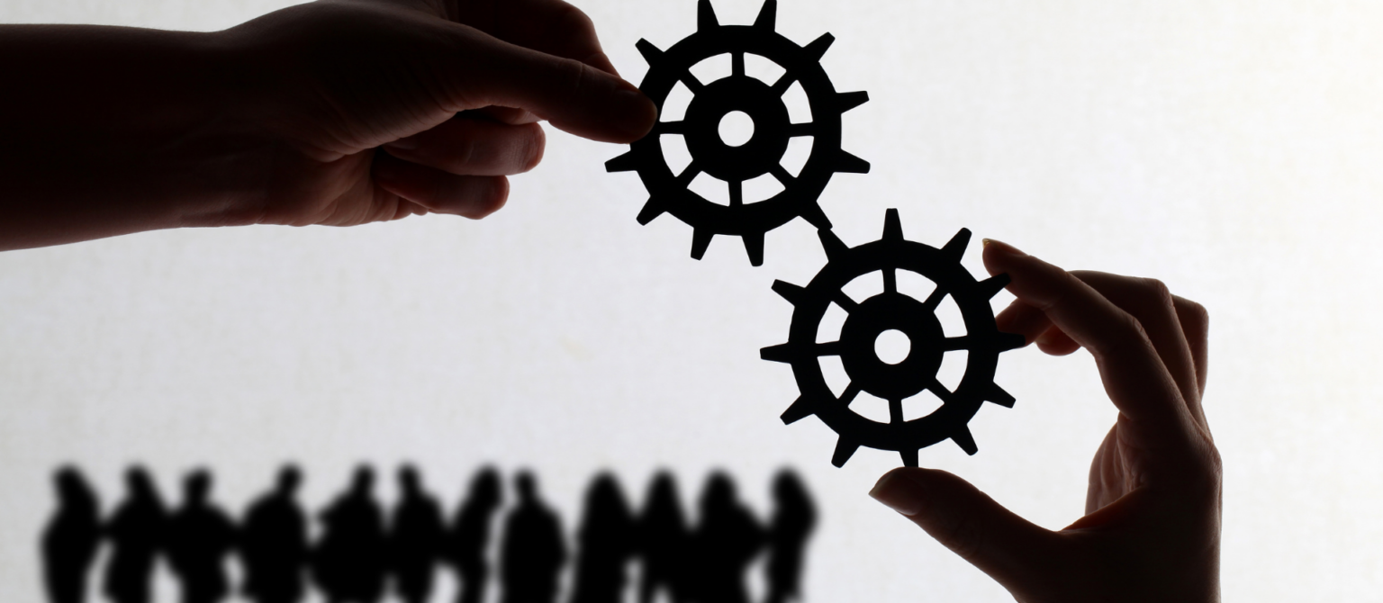 An image showing small gears represents alignment in B2B sales and marketing teams.