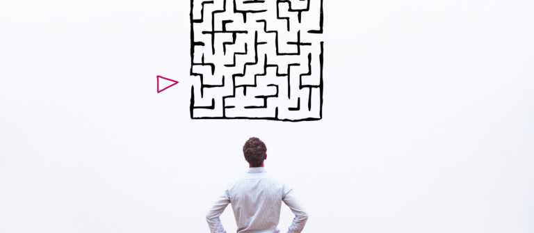 A man looking at a maze on a wall represents the challenge of simplifying complex tech content.