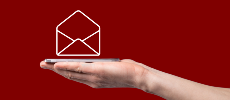A photo that includes an envelope graphic and a hand holding a cell phone represent writing short, relevant and compelling B2B marketing emails.