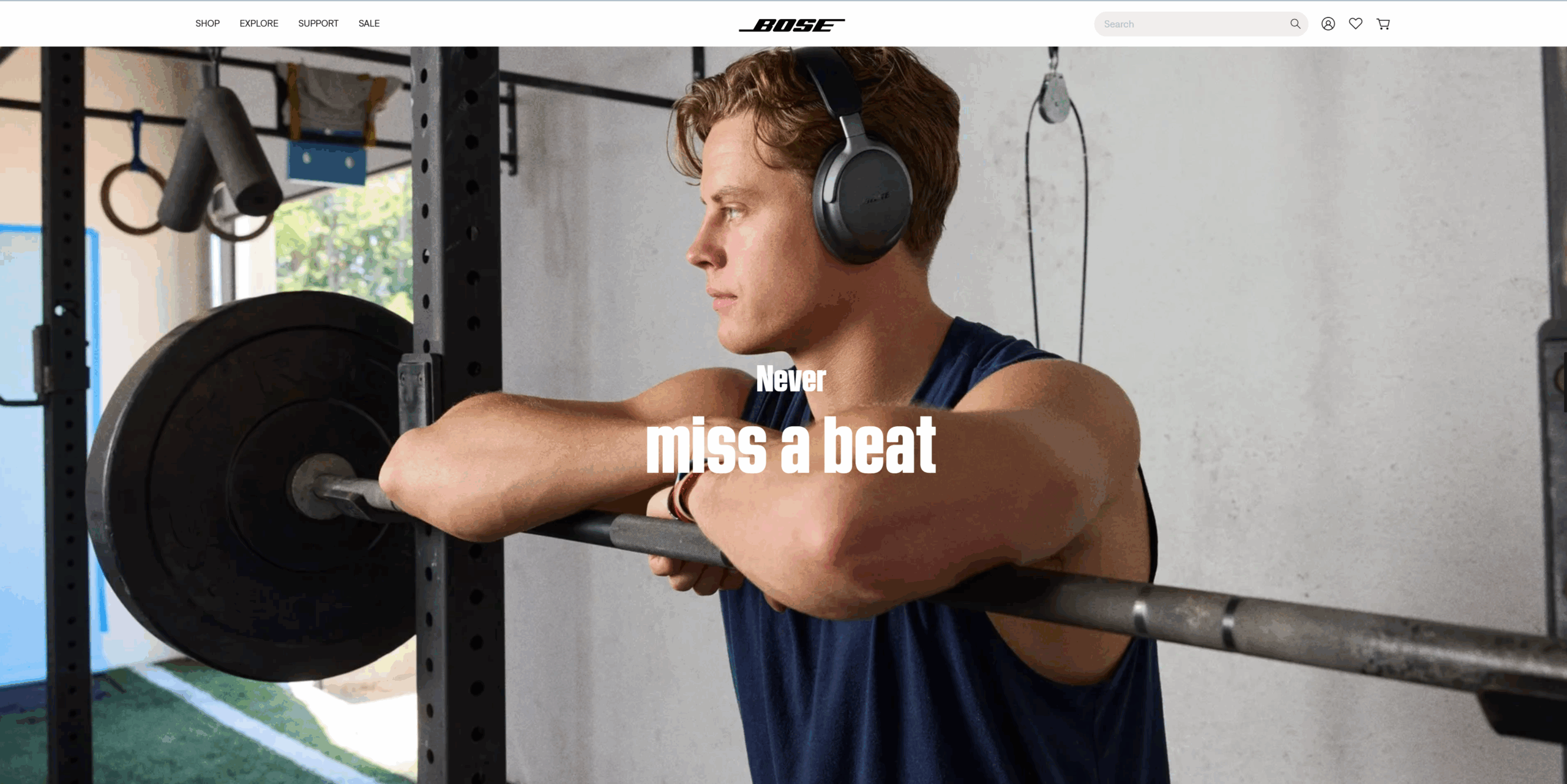 A screenshot from the Bose website of a man standing next to weights underscores how the consumer brand sells how people feel wearing its products.