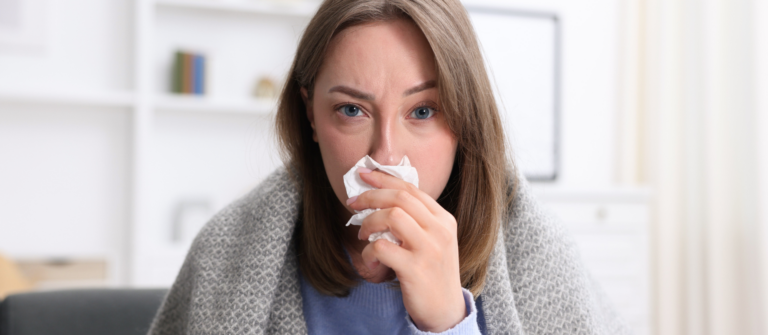 Woman holding a tissue, illustrating how B2B marketing data can look healthy while deeper problems remain hidden.