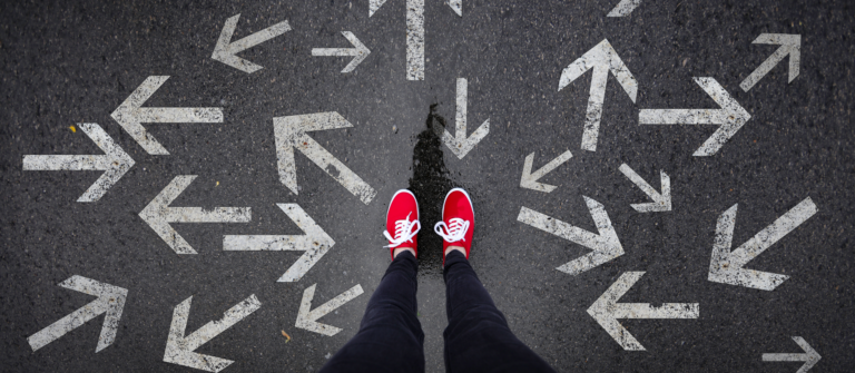 Person in red sneakers stands among arrows pointing in different directions, representing uncertainty about writing for AI search.