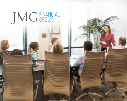JMG Financial Group team in conference room with JMG Financial Group logo in top left corner